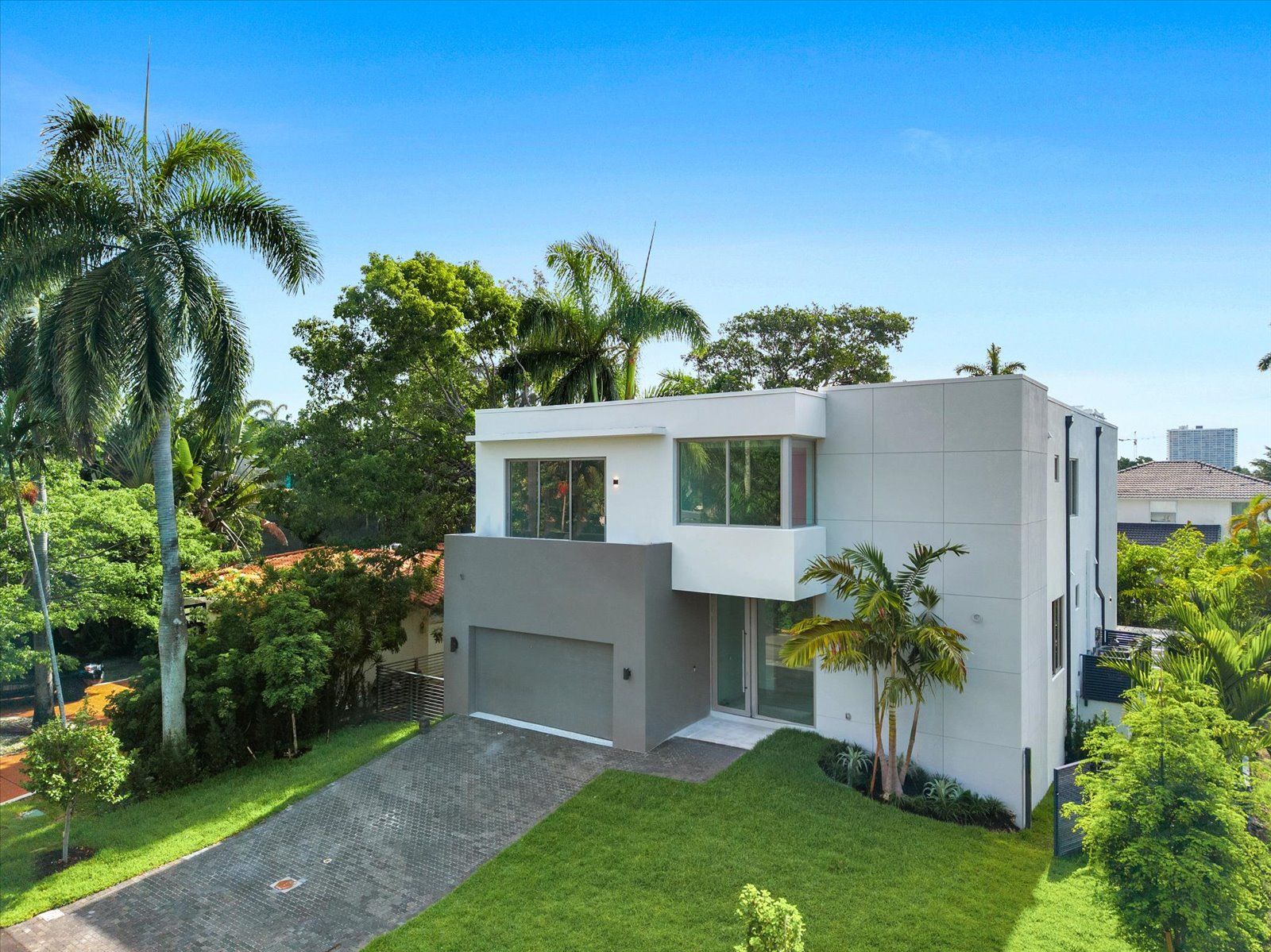 Casa Coquina — front elevation, a two-story modern white residence in North Bay Village