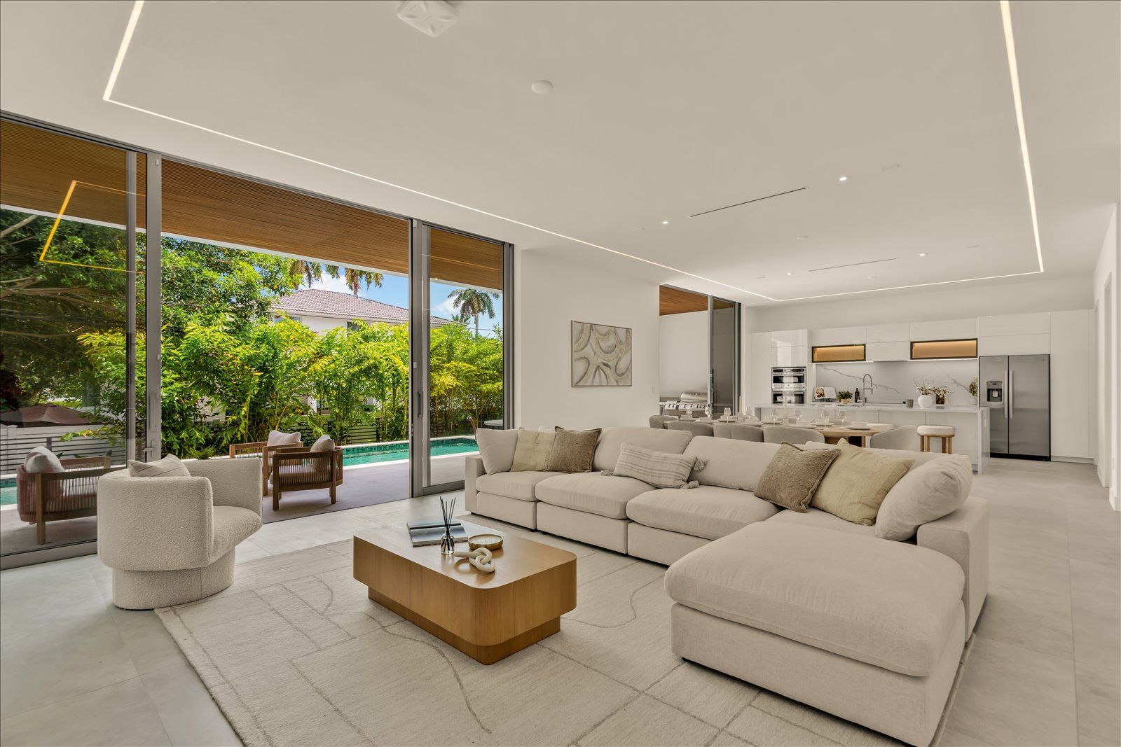 Great room with sliding glass walls opening to the pool