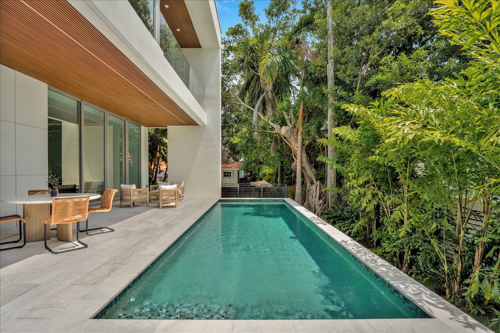 Pool terrace framed by mature tropical landscaping